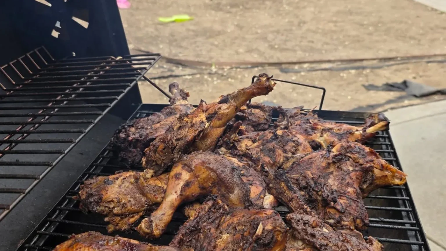 Jerk chicken cooking on the charcoal grill at Island Pullup