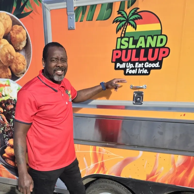 Kevin Buchanan, owner of Island Pullup, beside the truck