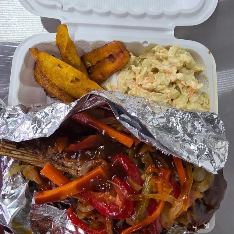 Fried escovitch fish with jerk sauce, fried plantain and macaroni salad