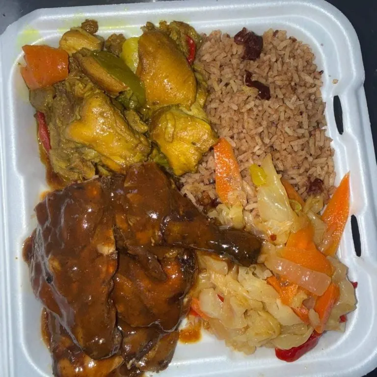 Curry chicken and jerk chicken mix with rice and peas and cabbage